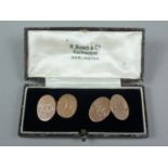 An early 20th Century gentleman's pair of 9ct gold cuff links, of oval shape, engraved with the