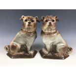A Victorian handed pair of Bo'ness Pottery pugs, of Staffordshire type, the dogs each modelled in