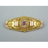 A Victorian diamond, ruby and 9ct gold Etruscan revival brooch, of lenticular form, the gemstones