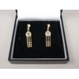 A contemporary pair of 9ct gold and aquamarine ear pendants inspired by Charles Rennie Mackintosh