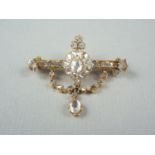 A late Victorian rose cut diamond bar brooch, having central flower head cluster, with principal