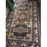Turkish Caucasian style rug with triple medallion design on a beige ground with borders