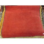 Small Tibetan rug with a plain red ground