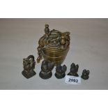 Graduated set of brass bucket weights in antique style together with five bronze opium weights