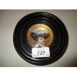 Small Continental porcelain concave plaque painted with a portrait of a lady wearing a feathered