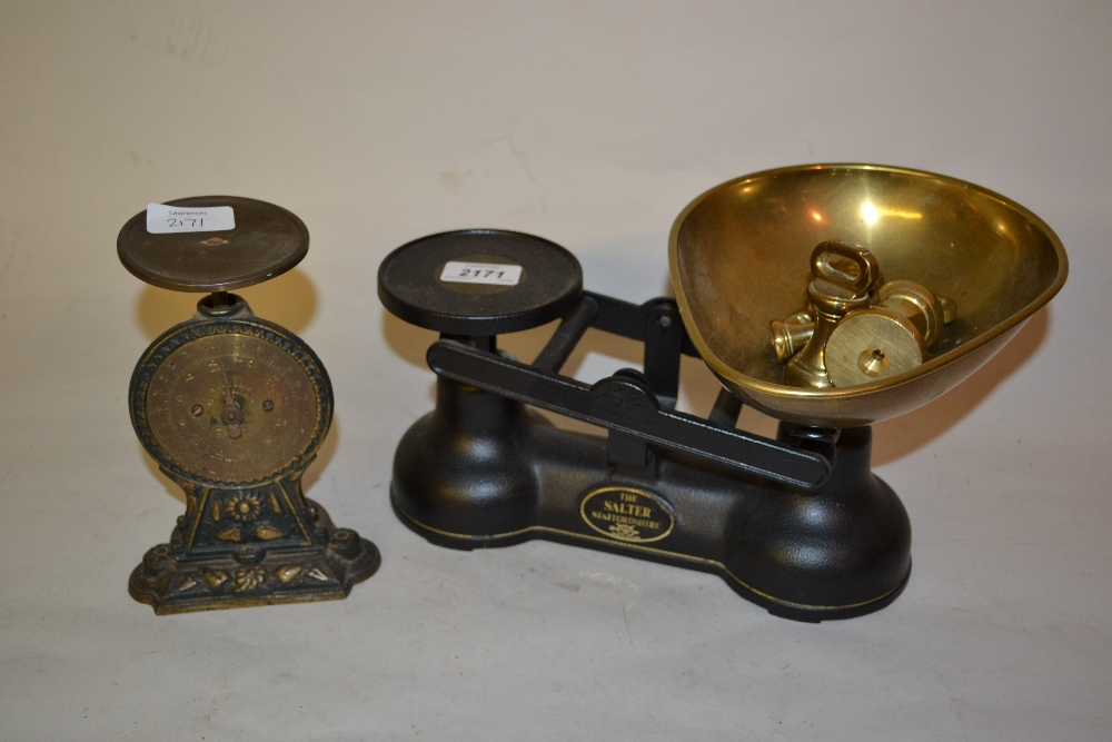 Pair of black Salter kitchen scales with small set of brass bell form weights,
