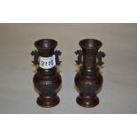 Pair of small late 19th Century Japanese dark patinated bronze baluster form vases with figural