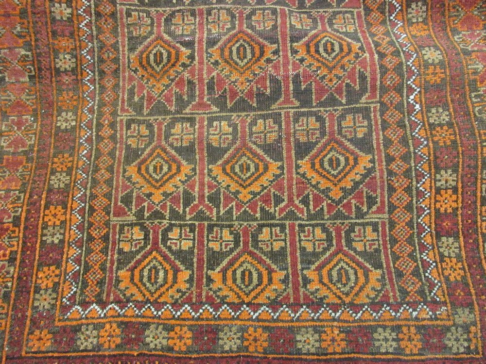 Small Afghan Belouch rug with all-over stylised floral design together with a small Afghan Belouch