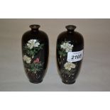 Pair of small Japanese cloisonne baluster form vases decorated with flowering peony on a black