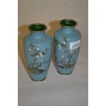 Pair of Japanese cloisonne vases decorated with birds in foliage on a pale blue ground,