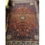 Abadeh rug of medallion and all-over floral design on a red ground with multiple borders,