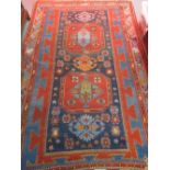 Kazak rug with a twin medallion design on a midnight blue ground with borders,