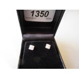 Pair of 18ct white gold diamond solitaire stud earrings in square mounts