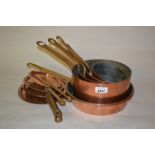 Graduated set of four copper saucepans with brass handles and lids by Leon Jaeggi and Sons Ltd.