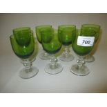 Seven port glasses with green cups,