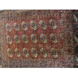 Small Belouch rug with an all-over stylised floral design on dark ground together with a small