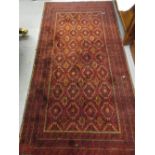 Afghan rug with an all-over geometric design on red ground with borders,