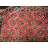 Small Belouch style rug with an all-over gol design on a wine ground with borders,