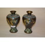 Pair of Japanese cloisonne baluster form vases decorated with yellow dragons on a black ground, 6.