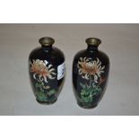 Pair of small Japanese cloisonne vases with floral decoration on a black and foil ground,