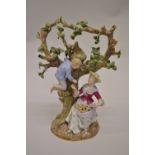 Meissen group of a figure seated at the base of a fruit tree with a boy climbing in the branches