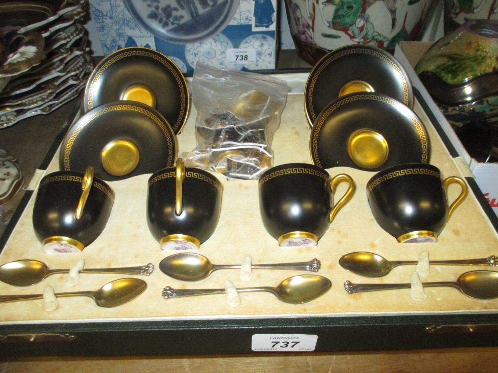 Cased part set of Royal Worcester black and gilt coffee cups with saucers together with six silver