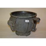 Large Japanese dark patinated metal jardiniere decorated in high relief with elephant and tiger