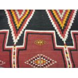 Kelim rug with geometric design in shades of red, black and orange,