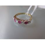 Seven stone ruby and diamond set ring