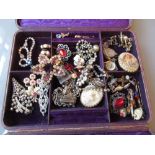 Leather jewellery box containing a quantity of various costume jewellery
