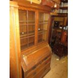 Edwardian oak bureau bookcase, the moulded cornice above a pair of bar glazed doors,