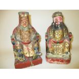 Two antique oriental carved wooden gilt and painted figures of seated oriental Emperors (a/f),