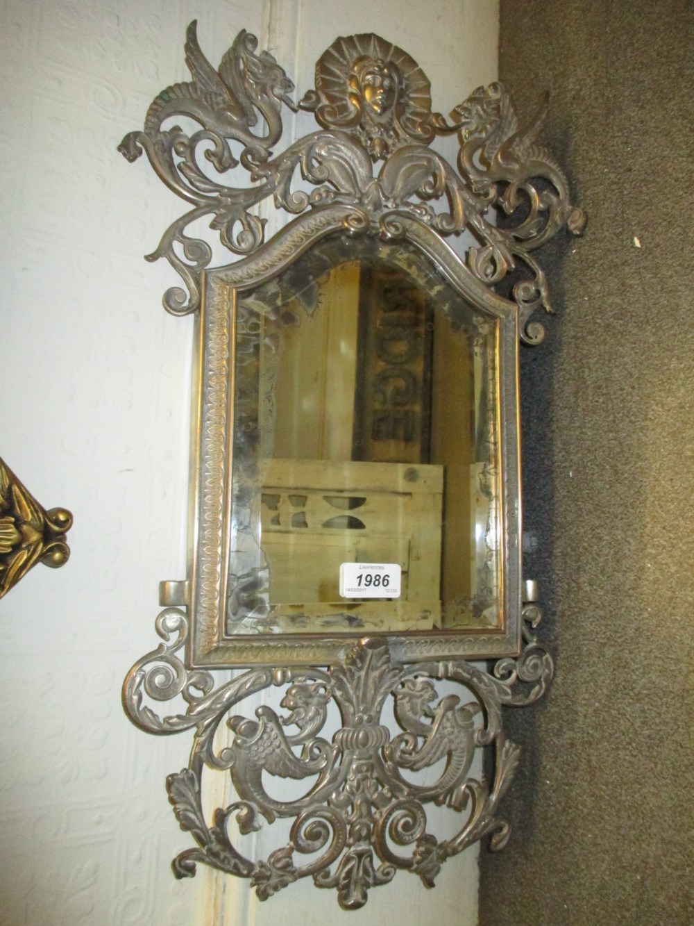 Late 19th or early 20th Century silvered metal wall mirror with pierced gryphon crest surmount