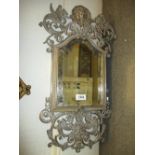 Late 19th or early 20th Century silvered metal wall mirror with pierced gryphon crest surmount