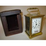 Small brass cased carriage clock with enamel dial,