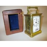 Small brass cased carriage clock with enamel dial and Roman numerals,