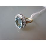 Yellow gold oval aquamarine and diamond cluster ring