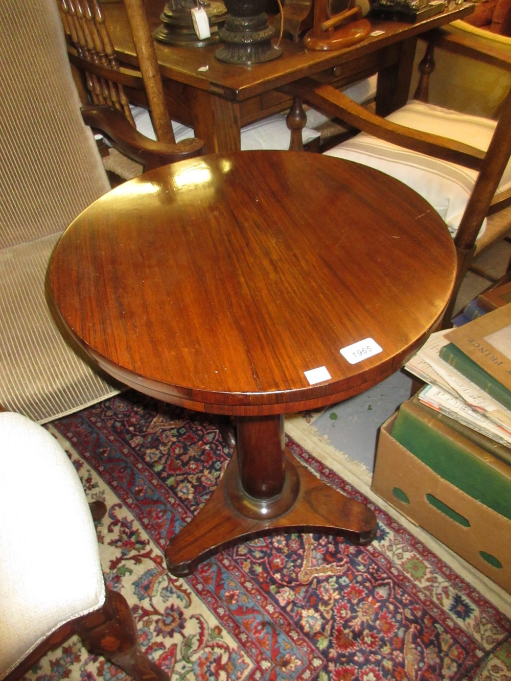 Victorian rosewood circular pedestal table with a plain turned column support and tri form base
