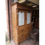 Victorian pine linen press with moulded cornice above a pair of glazed doors,