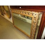 Rectangular gilt framed overmantel mirror having carved scrolled and pierced border,
