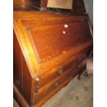 Large 20th Century oak bureau having fall front enclosing fitted interior above two short and one
