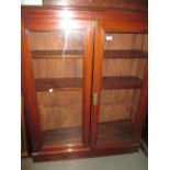 Late Victorian walnut two door glazed bookcase on a plinth base