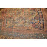 Kurdish rug with polychrome all-over design on a blue ground together with a small belouch rug