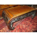 Early 20th Century Chinese carved hardwood scribes table with a carved frieze raised on shaped feet