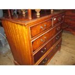 Reproduction figured walnut straight front chest of two short and three long drawers on bracket