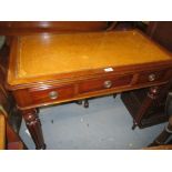 Small Victorian three drawer writing table with a leather inset top on turned fluted supports