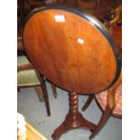 19th Century mahogany circular tilt top pedestal table with ebonised moulded top on a barley twist