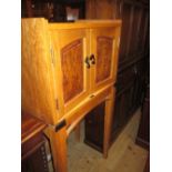 20th Century oak and burr walnut music cabinet with a pair of doors having handles in the form of