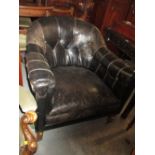 Late 19th or early 20th Century buttoned leather upholstered tub shaped drawing room chair raised