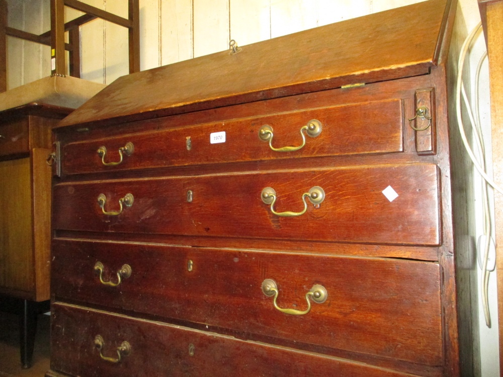 George III oak bureau with a fall front above four graduated drawers,